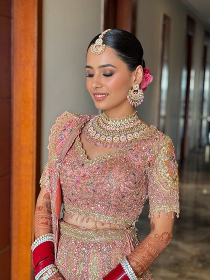Harsheen's Anand Karaj look was breathtaking. Her intricately embroidered pastel lehenga was paired with a flawless base, soft pink eyeshadow, and a sleek bun adorned with a flower.