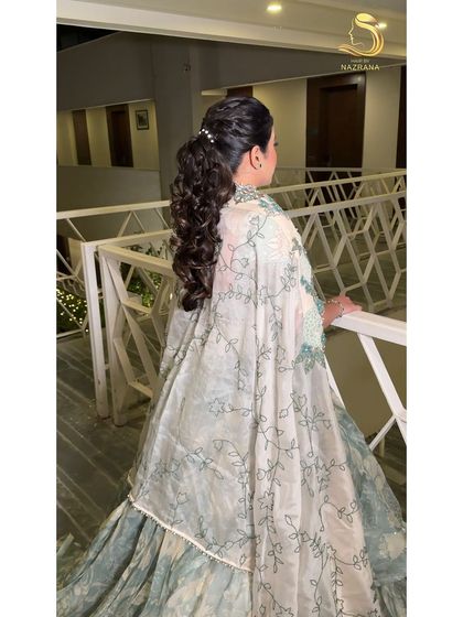 The final look of a textured ponytail with a pearl accessory, perfect for an elegant evening.