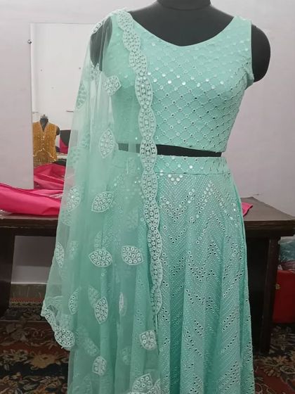 Another angle of the mint green lehenga, showing the cut of the sleeveless blouse and the intricate patterns of the Chikankari work.
