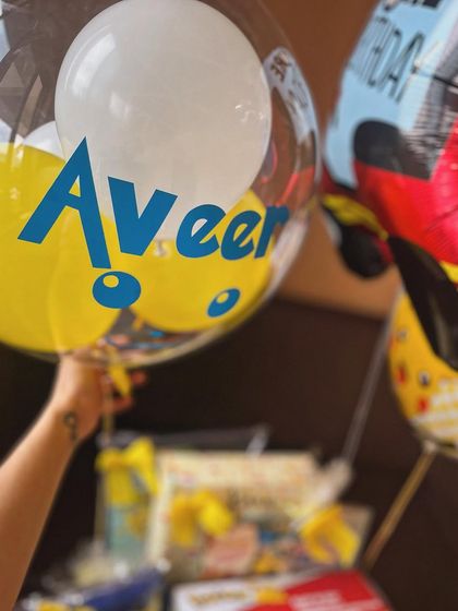 A personalized balloon with the birthday boy's name, adding to the custom feel of the entire gift.