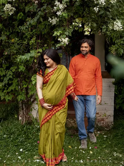 A candid walking shot of the couple through a garden path. These relaxed, in-motion photos capture the easy and joyful connection between partners as they look forward to their new beginning.