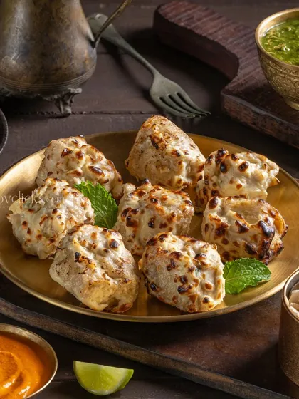 Malai Chicken Tikka, perfectly charred and creamy. This appetizer shot for The Mughal House uses traditional platters to create an authentic feel.