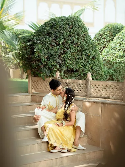 A sweet kiss shared by the couple during their Haldi photoshoot. These are the intimate moments that tell their love story.