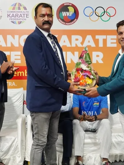 A formal moment of exchange at the inauguration of the Pune Kumite seminar. We collaborate with various state associations and officials to ensure our training programs have a wide reach.