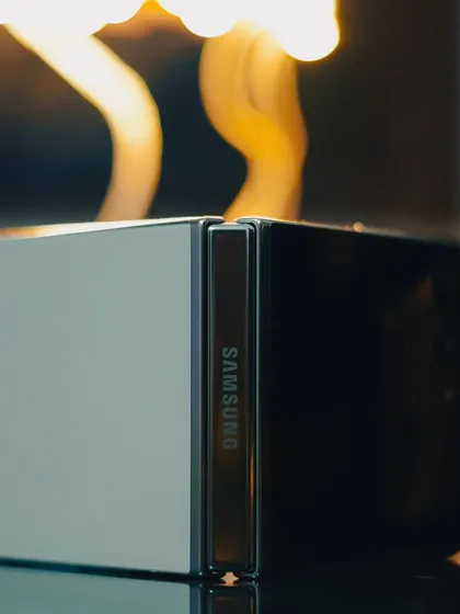 This abstract product shot of the Samsung Galaxy Z Flip 5 uses creative lighting to emphasize the phone's unique hinge design and premium build quality, offering a more artistic take on tech photography.
