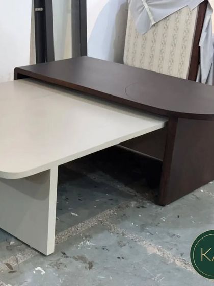 The same two-tone coffee table, shown on the workshop floor. This view highlights its solid construction and the clean lines that define its contemporary aesthetic.