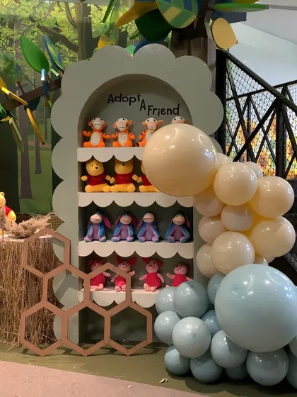 An "Adopt a Friend" station where each child could take home their own plush character from the Hundred Acre Wood.