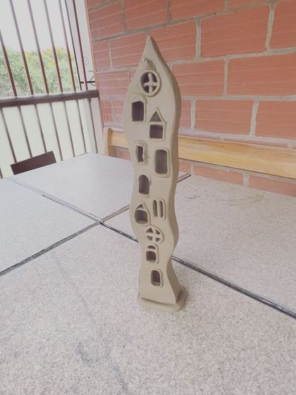 Another view of my wavy lamp sculpture, standing on a table in my studio.