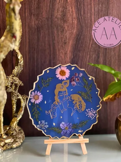 Bring divine love into your home with a custom Radha Krishna frame. This piece, set against a deep blue background and adorned with real flowers, is perfect for your altar or as a thoughtful gift.