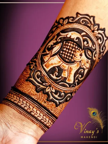 A bold wristband design featuring a majestic elephant in a decorative frame. This is a powerful statement piece.