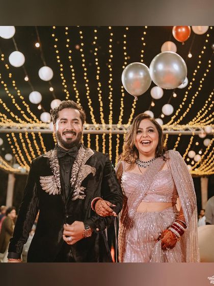 The happy couple makes their entrance at the reception, their smiles lighting up the room.