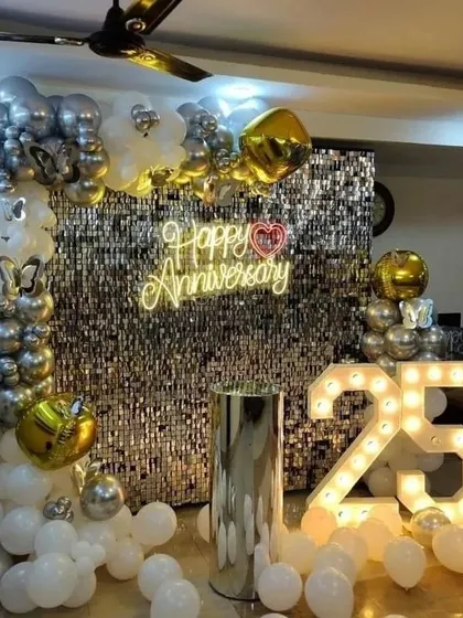 Celebrating a 25th anniversary with a glamorous silver sequin backdrop, a custom neon sign, and large marquee numbers. This elegant setup is perfect for major company milestones and creates a fantastic photo opportunity.