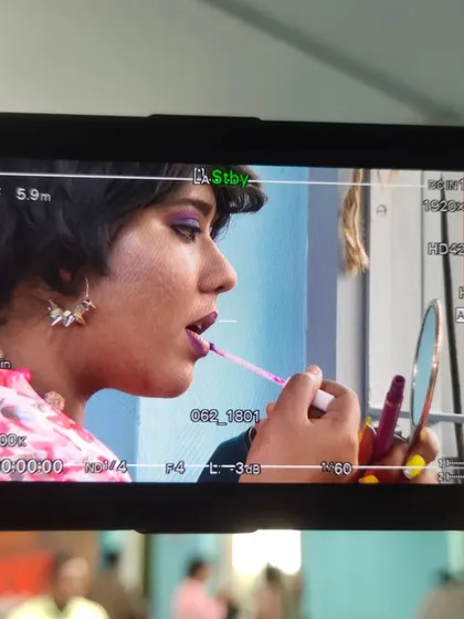 A candid behind-the-scenes shot from our "Nikki Raid" show. A quick touch-up before the camera rolls.