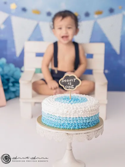 A happy shout of birthday joy! The focus on the cake with the birthday boy in the background creates a fun and artistic composition.