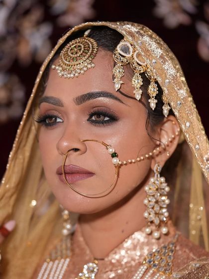 This bride is wearing a beautiful Polki and pearl set. The large nath and maang tikka are also available to rent separately or as part of a set.