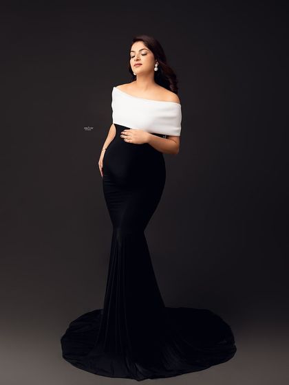 A full-length view of the elegant black and white eclipse gown, showing how to pose your client to create a beautiful S-curve shape.