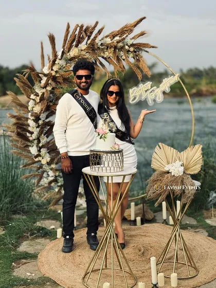 The perfect picture from a riverside couple's celebration, featuring our custom pampas grass arch.