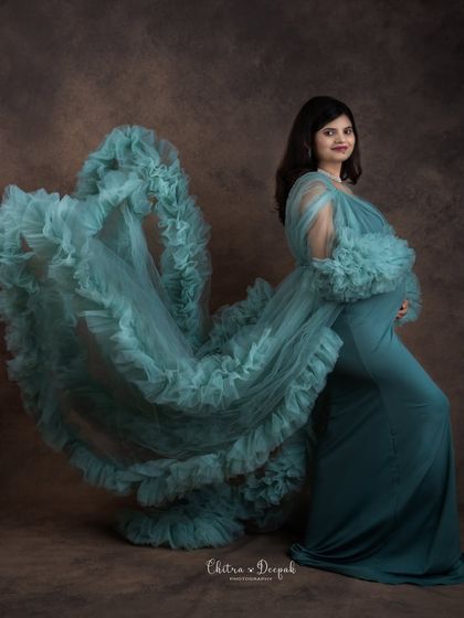 The beauty of movement. We love capturing the flow and toss of our gowns, like this sea-green dress, to create dynamic and artistic portraits.