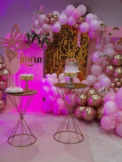A sophisticated butterfly-themed party with pink and gold decor. This setup is perfect for an elegant celebration, featuring stylish dessert tables and a beautiful balloon arrangement.