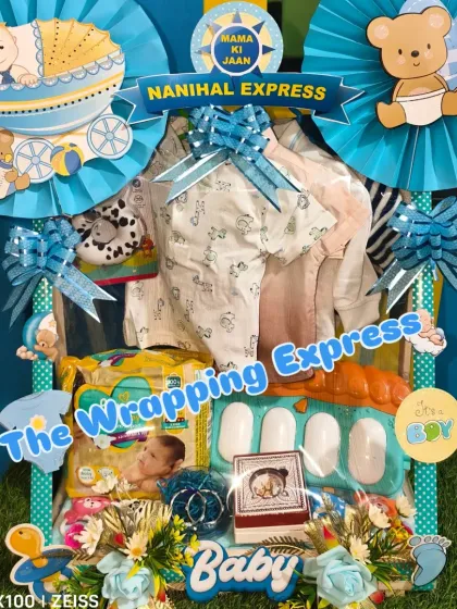 A custom baby hamper with a 'Mama Ki Jaan' banner, filled with diapers, a mini piano toy, and clothes.