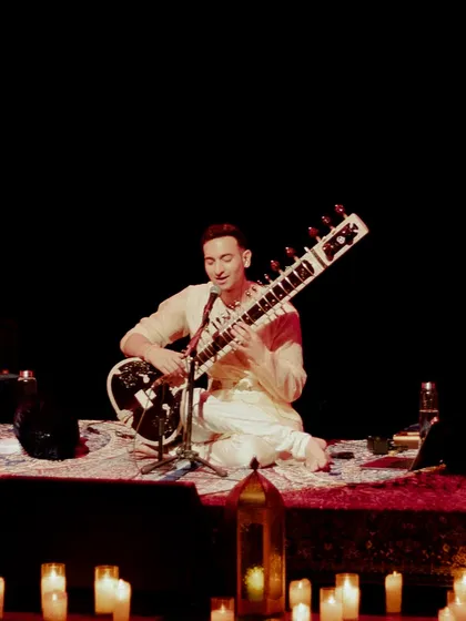 A moment of performance in Chandigarh, surrounded by lanterns and candles. The traditional decor helps root the modern mental health conversation in ancient practices of sound healing.