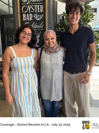 Three alumni pose for a photo at the LA reunion, bridging generations of our school's history.