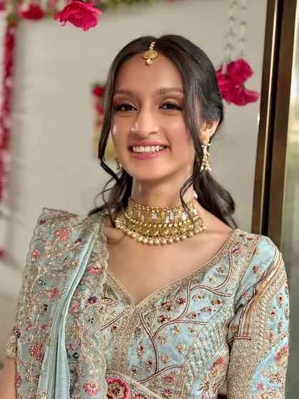 Modern brides are often choosing softer, pastel outfits. This makeup look was designed to complement a beautiful powder blue lehenga, featuring fresh, rosy tones and a natural glow for a pre-wedding event.