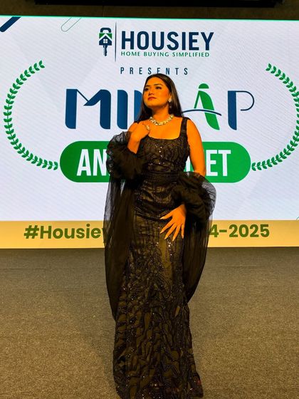 A confident pose on the Housiey stage. My body language is open and engaging, inviting the audience to connect with me.