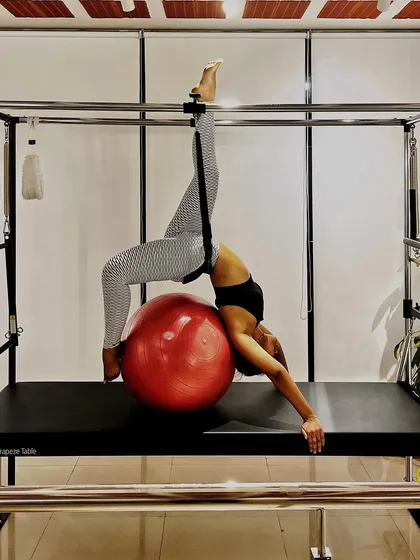 We are conquering the Cadillac pose with inner strength and determination. This backbend over the stability ball requires both flexibility and control.