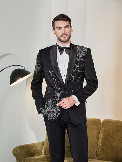 This ceremonial black tuxedo features stunning hand-embroidery in a firework-like pattern, designed for the man who embraces sartorial style. It's a piece that balances classic sophistication with bold, artistic expression.
