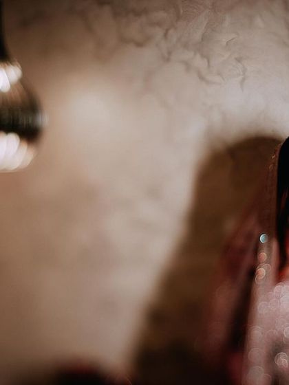 A portrait of a Muslim bride in a stunningly embellished gown, captured in a moment of quiet elegance.
