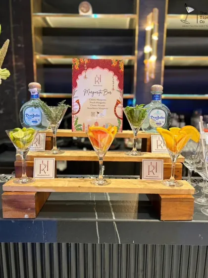 This is our interactive Margarita Bar. We set up a tiered display with various fresh fruit garnishes like lime, grapefruit, and orange, allowing guests to customize their Don Julio margaritas.