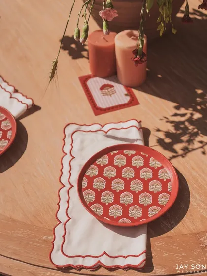 For the "Red Affair," even the tableware was part of the design. These custom plates with a traditional block-print motif, paired with scalloped napkins, added a touch of bespoke elegance to the dining experience.