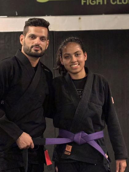 Head Coach Siddharth Singh with his student after her purple belt promotion. A moment of respect and acknowledgment of the hard work.