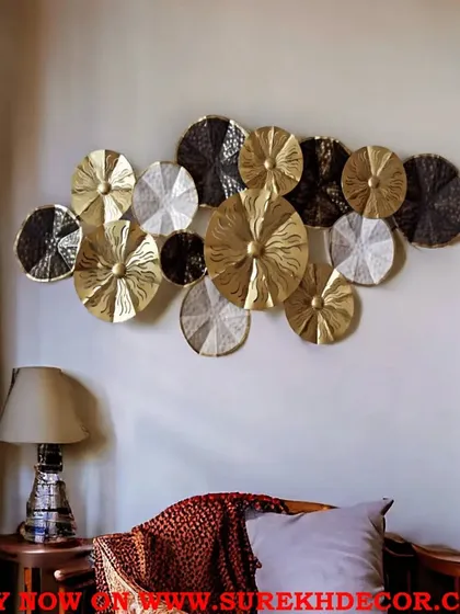 This multicolored metal wall decor features an array of floral-inspired discs in gold, silver, and black. The antique finish and textured surfaces create a rich, layered look that adds depth and interest to your wall.