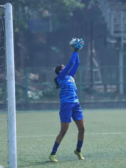 Our goalkeeper confidently catching the ball, showcasing safe hands and good positioning.