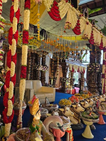A side view of the temple mandapam, showing the layers of floral garlands.