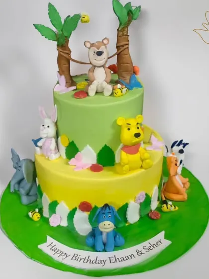 I brought the Hundred Acre Wood to life for Ehaan and Seher's birthday with this adorable Winnie the Pooh cake. Featuring Pooh and his friends, this two-tier jungle theme cake is perfect for a whimsical kids' party.