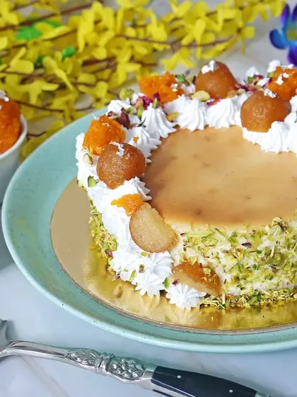 A beautifully styled shot of a Gulab Jamun fusion cake, combining traditional Indian sweets with modern baking. This type of creative food photography is great for bakeries and sweet shops wanting to highlight their unique menu items.