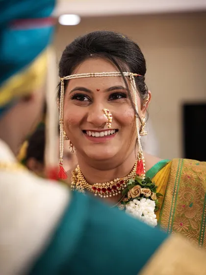 A candid, over-the-shoulder shot of the bride smiling at her groom. This captures a genuine moment of love and happiness.