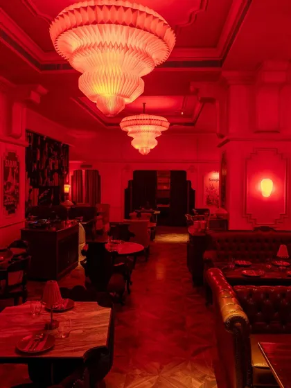 The lounge seating, where deep leather banquettes and ornate chandeliers create a sense of decadent comfort.