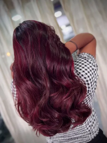For clients who want to make a statement, we love creating bold, beautiful colours. This deep burgundy red is rich, vibrant, and catches the light perfectly, showing off the healthy shine and soft waves.