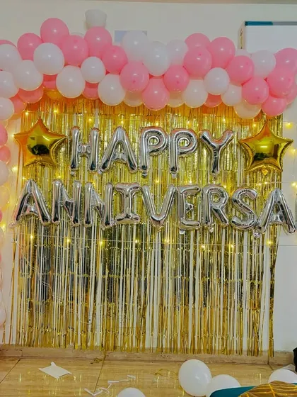 A clear, straight-on view of the pretty pink and gold anniversary backdrop.