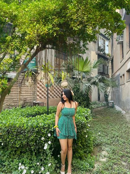 Another shot of the spring romper. The lush green background perfectly complements the color of the outfit.