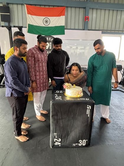 Celebrating together in the gym with traditional wear and a cake on a plyo box. Our box is a place for fitness and for celebrating life's moments.