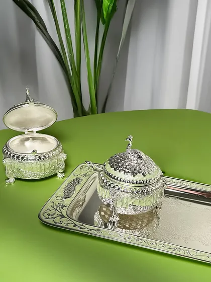This set, featuring two peacock-topped dry fruit boxes on an enamel tray, is perfect for grand celebrations. It allows you to serve a variety of treats while maintaining a cohesive and elegant look.