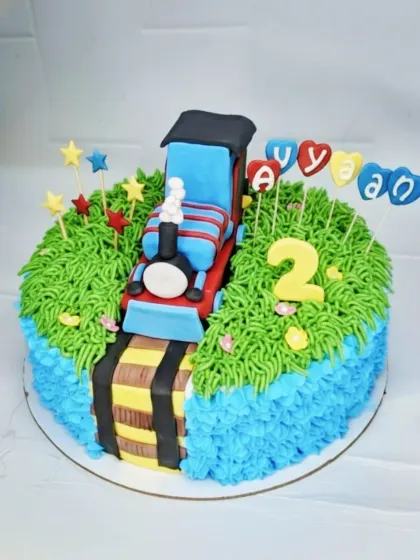 Choo choo! A fun train-themed cake for Avyaan's 2nd birthday. This fresh pineapple cake features a handmade fondant train on edible tracks.