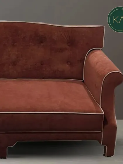 A detailed shot of the arm and back of the classic terracotta sofa, emphasizing the craftsmanship of the rolled arm, the tufting, and the contrasting piping.