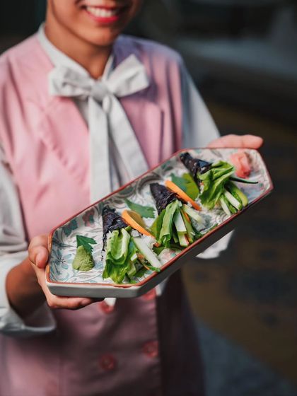 Our Zen Garden Temaki Roll, presented by a member of my team. It’s a hand-rolled marvel of crisp asparagus, frisée lettuce, and pickled vegetables.