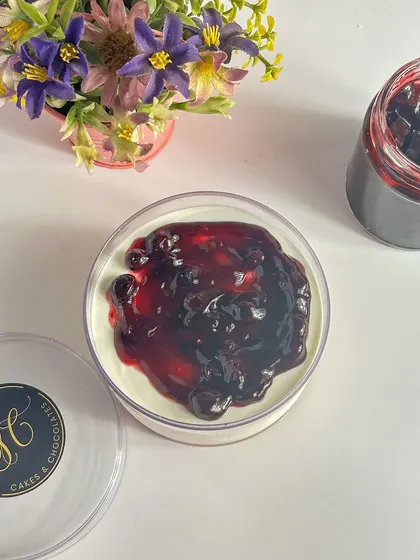 A top-down view of the Blueberry Cheesecake tub, showing the vibrant, natural color of the fruit compote.